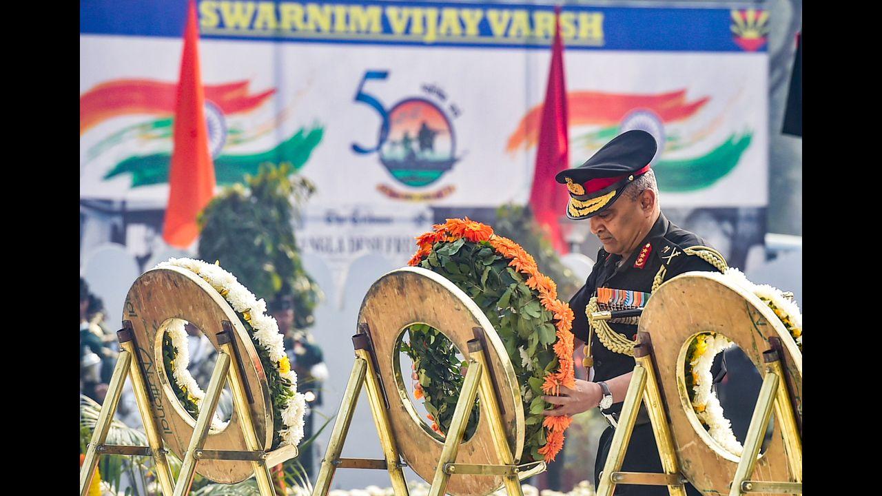 General Officer Commanding-in-Chief of Eastern Command Manoj Pande (C) pays tribute to martyrs on the occasion of 'Vijay Diwas' at Vijay Smarak in Kolkata. Pic/PTI